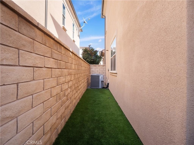 view of side of home featuring cooling unit