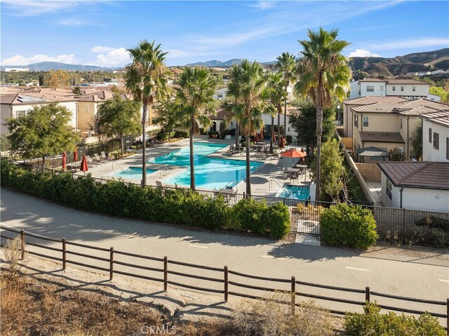 view of pool featuring a patio area and a mountain view