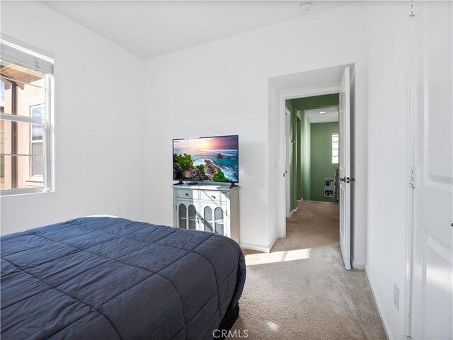 bedroom featuring light carpet