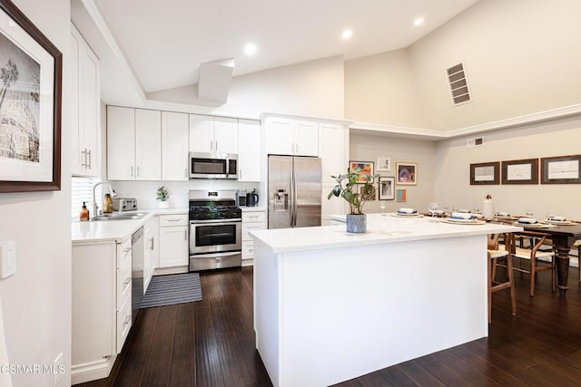 kitchen featuring sink, white cabinetry, appliances with stainless steel finishes, and a kitchen island