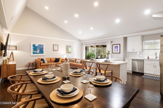 dining space with high vaulted ceiling, dark hardwood / wood-style flooring, and sink