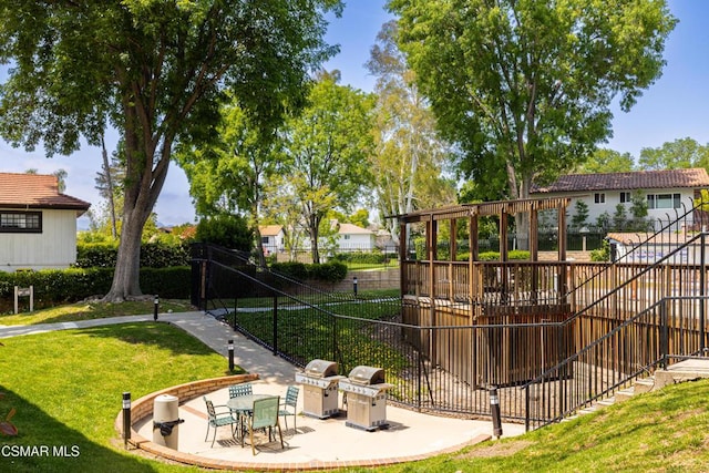 view of community featuring a yard and a patio