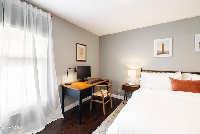 bedroom with dark hardwood / wood-style flooring