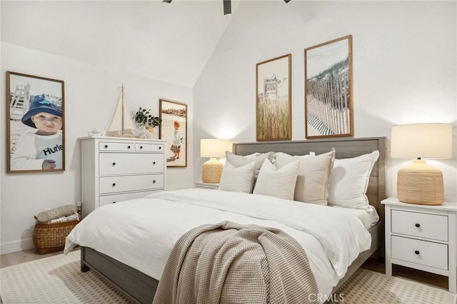 bedroom with lofted ceiling and light hardwood / wood-style flooring