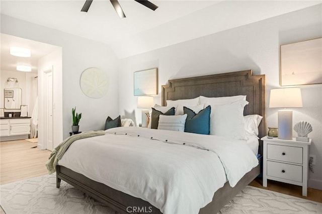 bedroom with ceiling fan, lofted ceiling, and light hardwood / wood-style floors