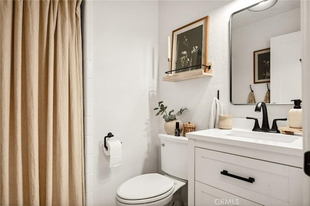 bathroom with toilet and vanity