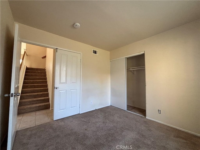 unfurnished bedroom with carpet and a closet