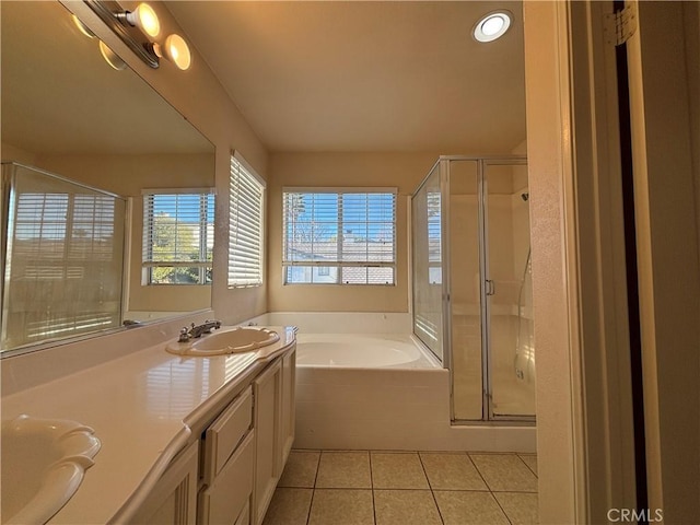 bathroom with vanity, tile patterned flooring, and plus walk in shower