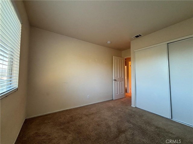 unfurnished bedroom featuring a closet and carpet