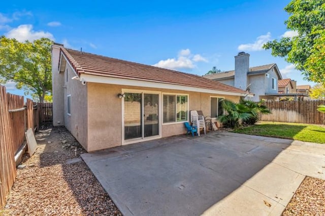 back of property with a patio