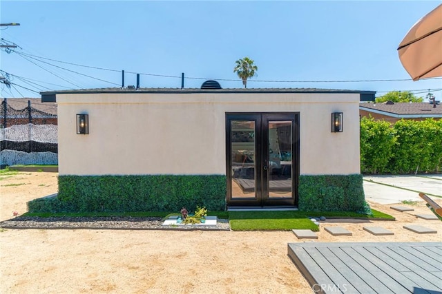 view of exterior entry featuring french doors