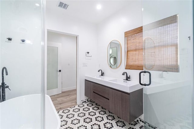 bathroom with vanity and independent shower and bath