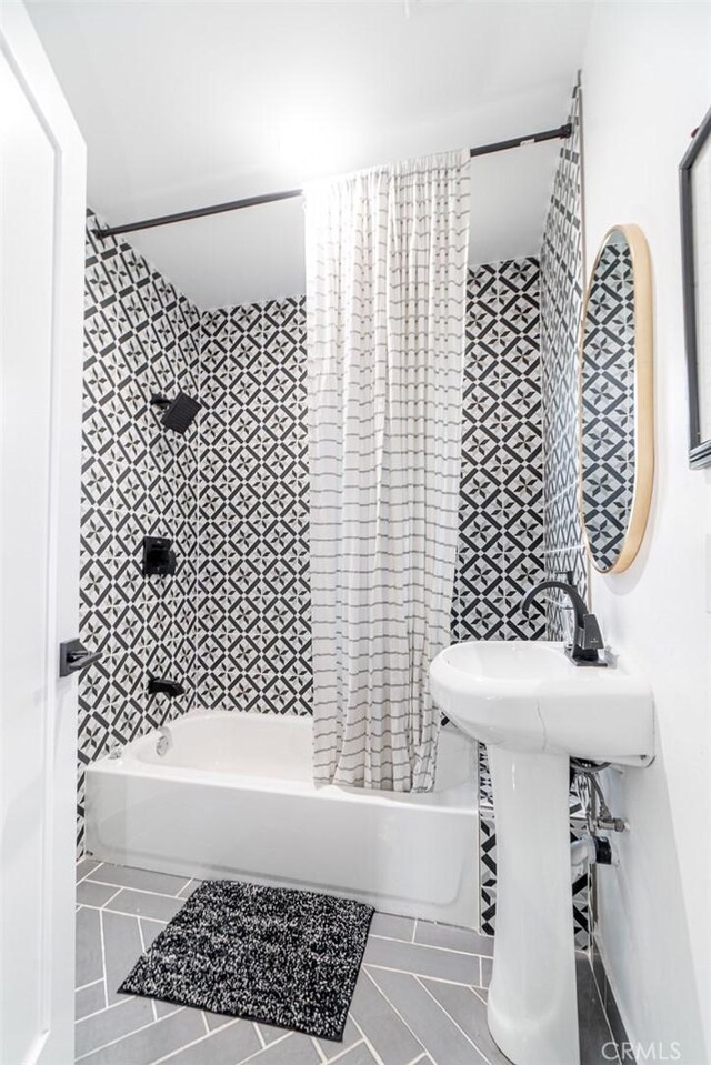 bathroom featuring tile patterned floors and tiled shower / bath combo