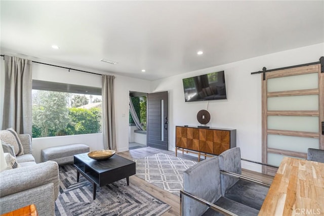 living room featuring hardwood / wood-style floors and a barn door