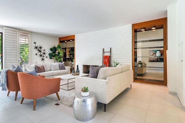 living room featuring light tile patterned floors and a fireplace