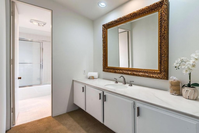 bathroom with combined bath / shower with glass door and vanity