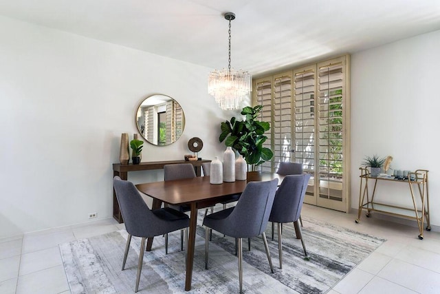 tiled dining room featuring an inviting chandelier