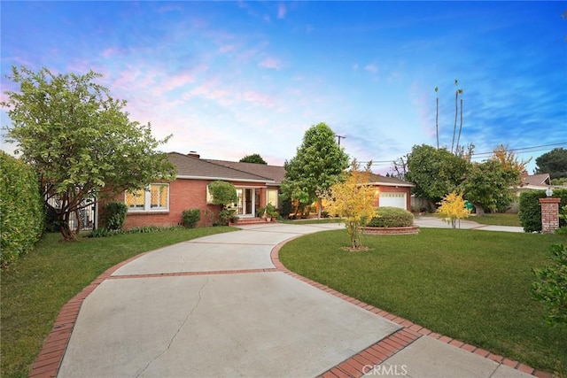 view of front of home featuring a garage and a front lawn