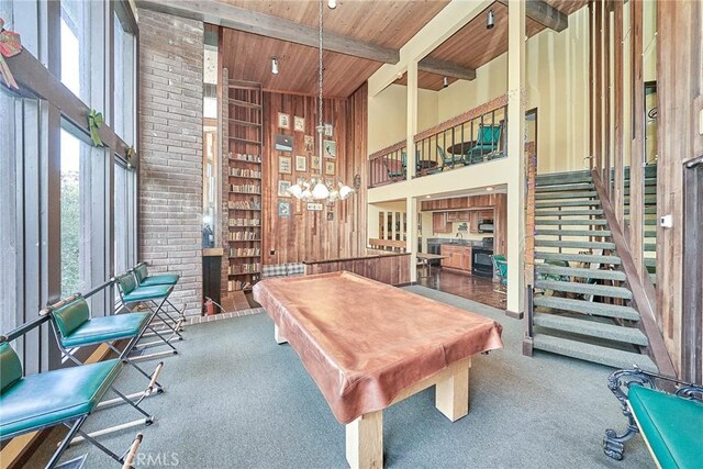 game room with beamed ceiling, wooden ceiling, billiards, wooden walls, and a high ceiling