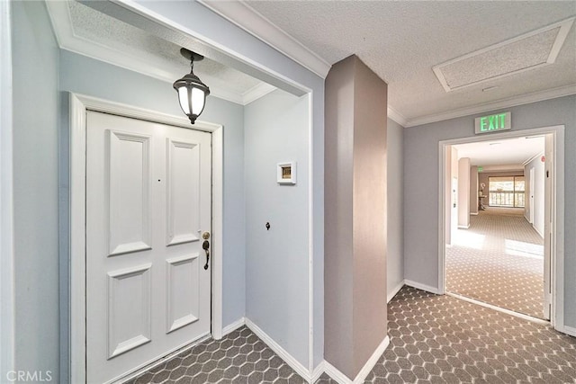 foyer entrance with a textured ceiling and ornamental molding