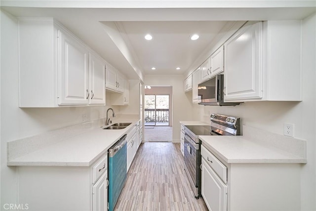 kitchen featuring light hardwood / wood-style floors, sink, white cabinets, and stainless steel appliances