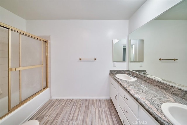 bathroom with vanity, enclosed tub / shower combo, and hardwood / wood-style floors