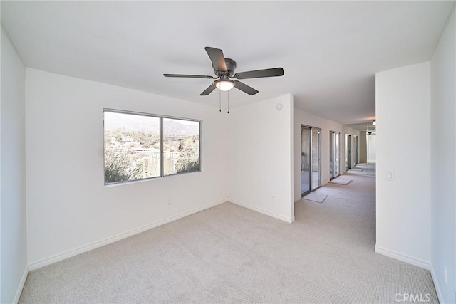 empty room featuring light carpet and ceiling fan