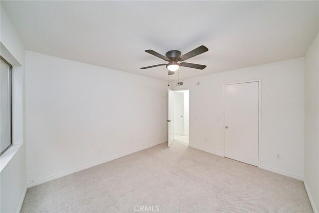 unfurnished bedroom featuring ceiling fan and light colored carpet