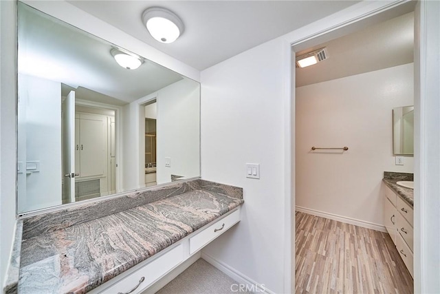 bathroom featuring hardwood / wood-style flooring and vanity