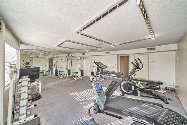 exercise room featuring a textured ceiling