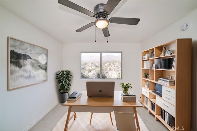 home office featuring light colored carpet and ceiling fan