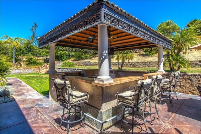 view of patio / terrace with a gazebo and a bar