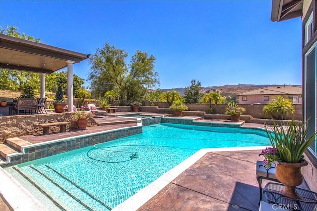 view of pool featuring a mountain view and a patio