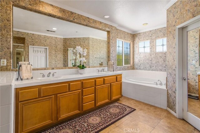 bathroom with a relaxing tiled tub, tile patterned floors, vanity, and crown molding