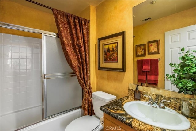 full bathroom with shower / bath combination with glass door, vanity, and toilet