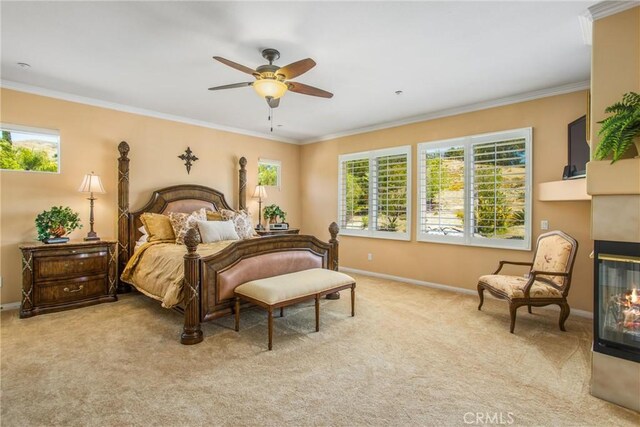 carpeted bedroom featuring ceiling fan, a multi sided fireplace, and crown molding