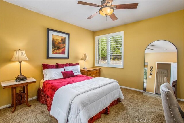 bedroom featuring ceiling fan and light carpet