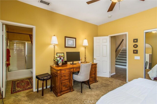 carpeted bedroom with ceiling fan and ensuite bathroom