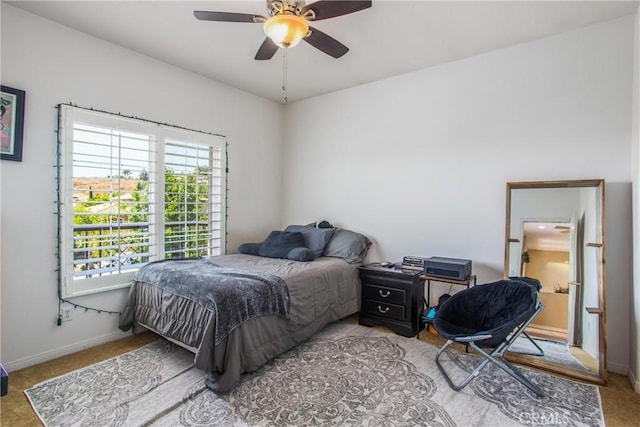 bedroom with ceiling fan and light carpet