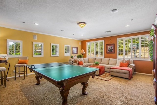 recreation room featuring a textured ceiling, ornamental molding, and carpet flooring