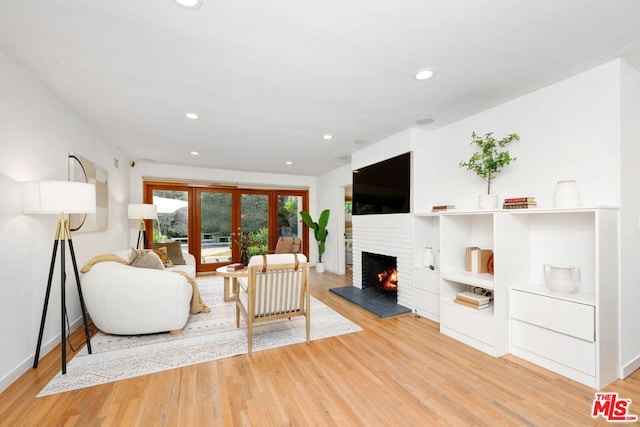 living room featuring french doors and light wood-type flooring