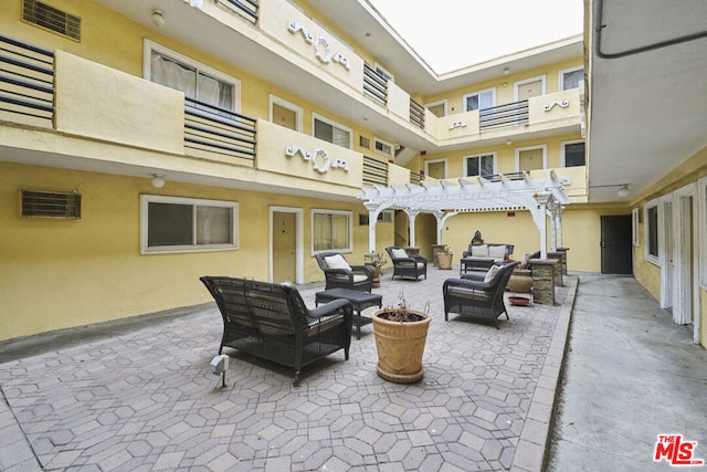 view of patio featuring outdoor lounge area and a pergola