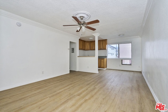 unfurnished living room with light hardwood / wood-style floors, a textured ceiling, and crown molding