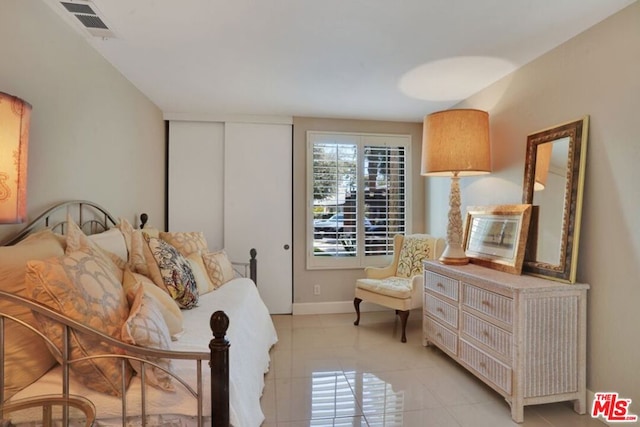 bedroom featuring light tile patterned flooring