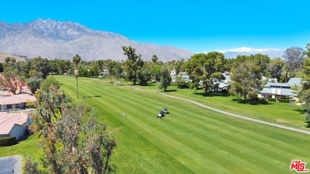 surrounding community featuring a mountain view and a yard