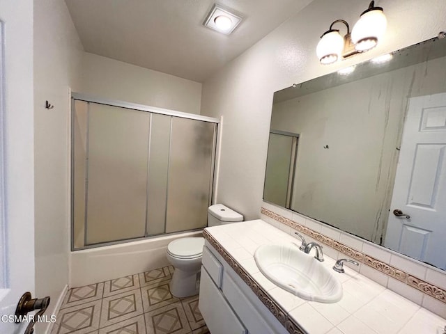 full bathroom featuring bath / shower combo with glass door, toilet, vanity, and tasteful backsplash