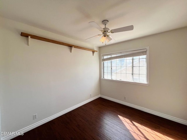 spare room with ceiling fan and dark hardwood / wood-style flooring