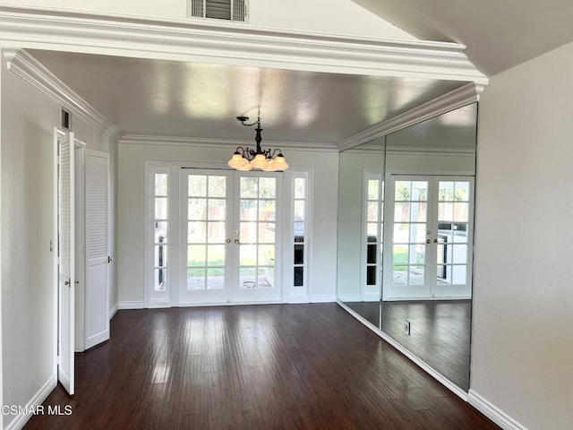 doorway featuring french doors, a notable chandelier, and crown molding