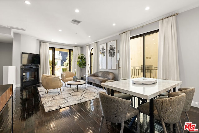 dining space featuring dark hardwood / wood-style flooring and ornamental molding