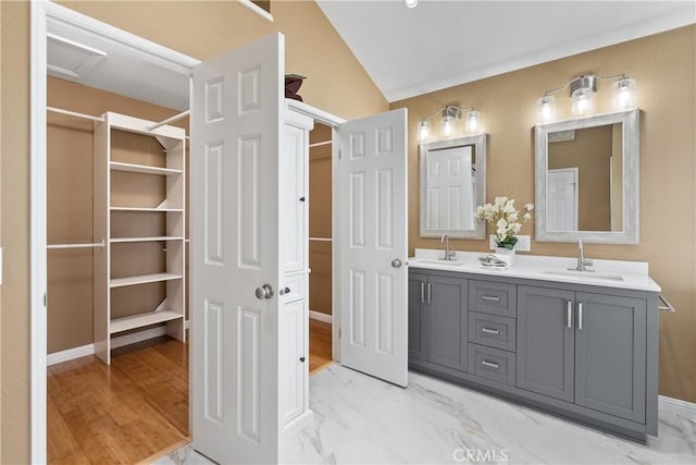 bathroom featuring vanity and vaulted ceiling